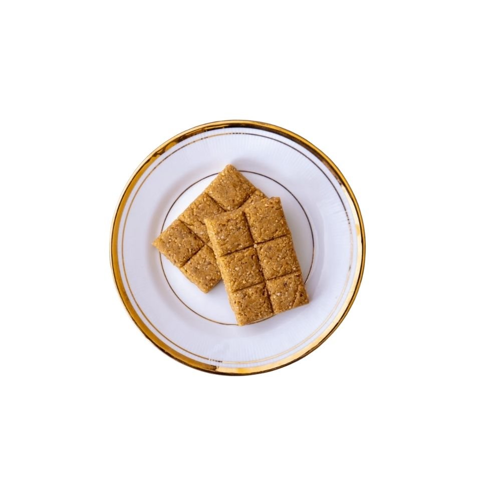 Crushed Peanut Chikki is a classic village-style sweet made by grounding roasted peanuts and mixing them with pure jaggery. Soft yet crunchy, mildly sweet, and full of nutty flavour, this traditional chikki melts beautifully in the mouth and brings back old-school snack memories.