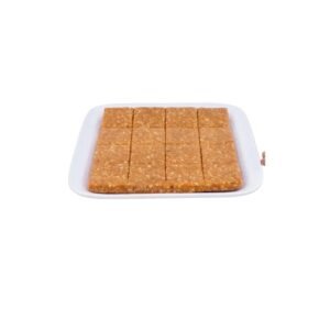 Crushed / Grounded Peanut Chikki – Pure, Nutty Goodness! A traditional Indian sweet made from freshly roasted peanuts and golden jaggery, crushed for a delightful melt-in-mouth crunch.